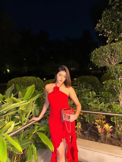 Another beautiful shot of the red dress, surrounded by lush greenery.