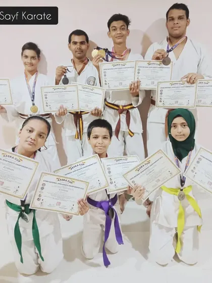 Our team of karateka winners from the Open Karate Championship. Seeing students of all belt levels, from green and yellow to brown, standing together with their awards is the best reward for an instructor.