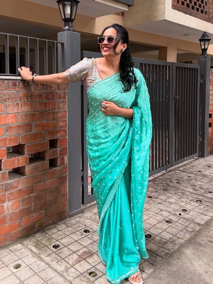 A stunning look in a turquoise sequined saree. This glamorous outfit is perfect for festive occasions or events, showcasing my ability to create high-fashion, celebratory content.