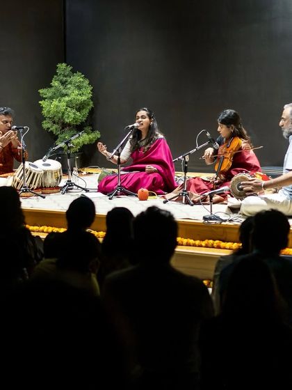 A wide shot of a traditional Carnatic concert at the Indian Music Experience. Performing in front of an audience, surrounded by my talented band, is where I feel most at home.