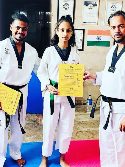 This young lady has earned her green belt. We are proud to present her with the certificate that marks her hard work and progress.