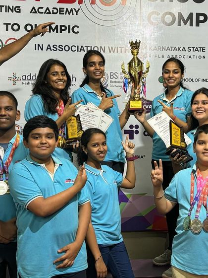 Our young champions celebrating with their trophy and medals after a successful run at the Best Shot Open Competition.