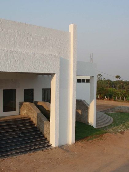 This image illustrates harmony in design, where the clean white surfaces, stone staircase, and natural landscape work together cohesively. Each element relates to the others through texture and form, creating a unified and balanced composition.