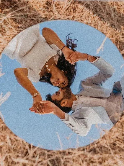 An award-winning pre-wedding shot that plays with perspective. Using a mirror, I captured the couple's reflection against the sky, creating a unique and artistic portrait that symbolizes their world together. This is the kind of creative photography I love.