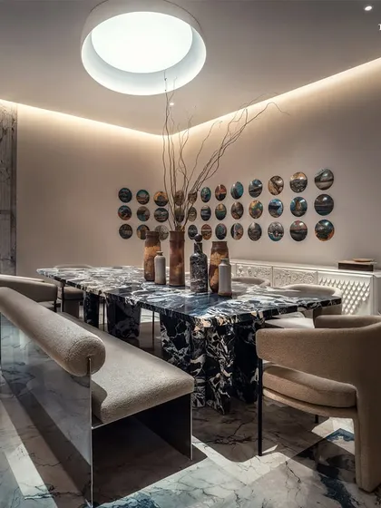 Anchoring the heart of this Mumbai residence in Palais Royale is a dining space that blurs the boundaries between sculpture and utility. A custom-designed monolithic dining table sits at the core, its circular silhouette fostering intimacy and reinforcing our devotion to spatial harmony.