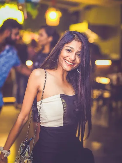 A guest smiling and enjoying the music at Gawky Goose.
