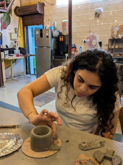 A close-up of a participant hand-building a pot. This technique doesn't use the wheel and is perfect for creating more organic or sculptural shapes.
