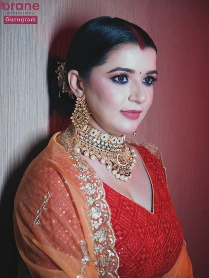 A close up shot that captures the rich colors and textures of the reception makeup and outfit.