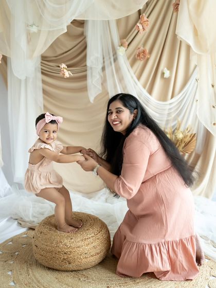 "AMMA". A mother helps her little one stand, a beautiful moment of support and love.