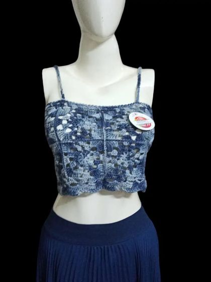 A closer look at the blue variegated yarn crop top. You can see the detailed stitch work and how the colors blend together to create a unique, almost tie-dye effect.