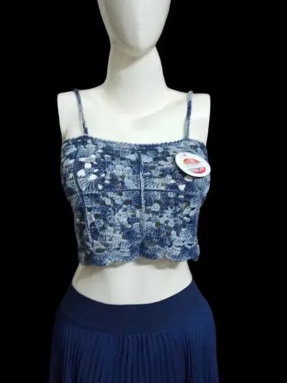 A closer look at the blue variegated yarn crop top. You can see the detailed stitch work and how the colors blend together to create a unique, almost tie-dye effect.