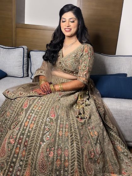 A soft smile from this stunning Sangeet bride. This image shows how the natural-looking makeup enhances her features without overpowering the intricate details of her outfit.
