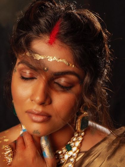 An artistic close-up, where traditional elements like the bindi are re-imagined in a modern, conceptual way.
