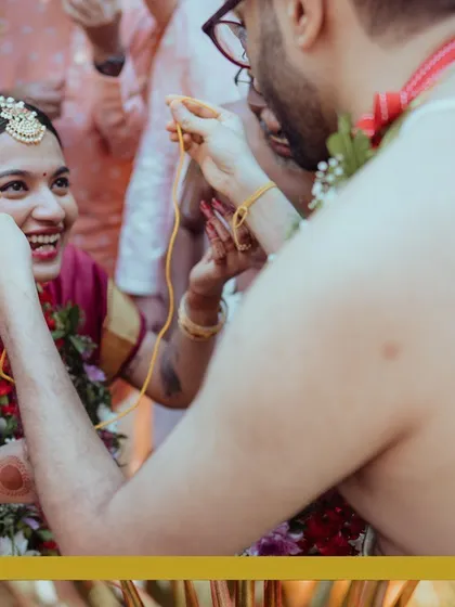 The groom ties the sacred thread, a significant moment in the wedding ceremony, filled with emotion and tradition.