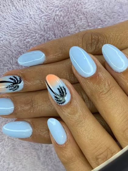 A cute vacation-ready set with a light blue base and accent nails featuring a sunset ombre and a palm tree.