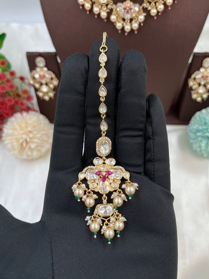 This collection showcases our premium Moissanite Kundan necklaces like the 'Noor Nazaakat' and 'Darbaar' sets. Each comes with a full set of earrings and maang tikka, available in various color combinations.