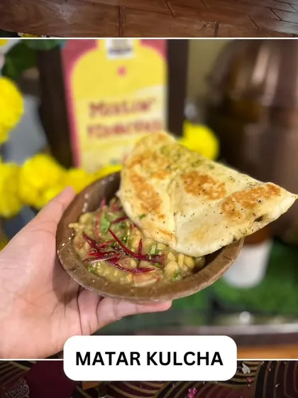 Classic Matar Kulcha, a popular North Indian street food dish. Soft, fluffy bread is served with a savory curry made from white peas.