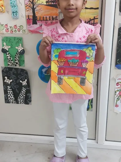This student's vibrant painting of a truck filled with flowers is so cheerful. I love seeing the unique color choices each child makes.