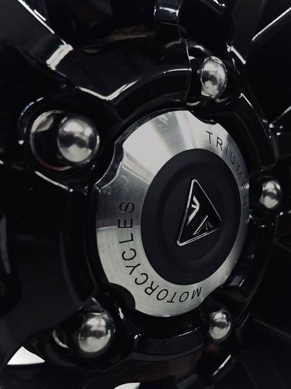 The Triumph Motorcycles logo on the rear wheel hub of the Rocket 3.