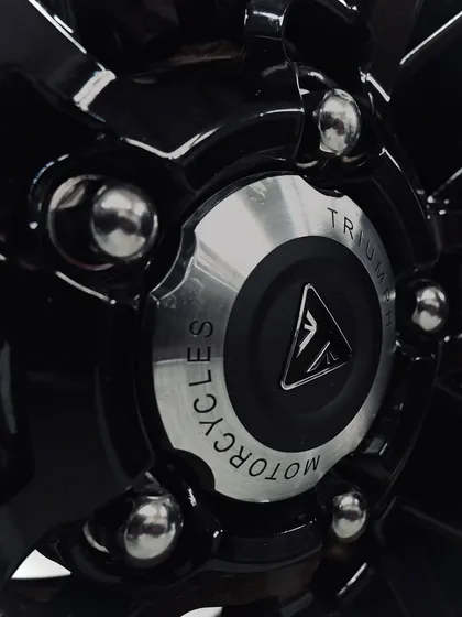 The Triumph Motorcycles logo on the rear wheel hub of the Rocket 3.