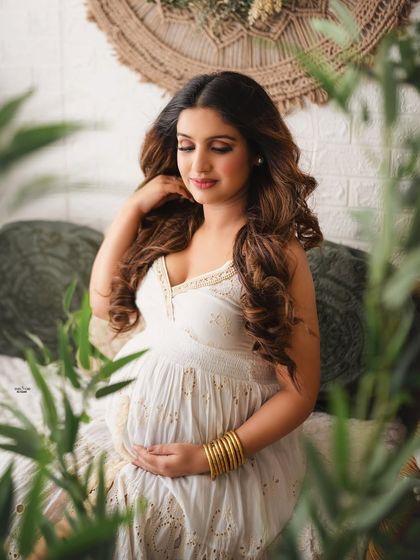 Capturing quiet, candid moments is key. This shot shows how to use foreground elements like plants to create depth and a sense of intimacy.