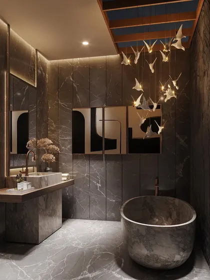 I transformed this master bath into a celestial haven. Layered lighting, including a skylight and a sculptural bird chandelier, highlights the textured stone walls and freestanding tub, turning the space into true bathroom goals.