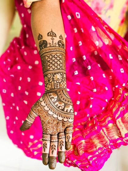 A single arm shot highlighting the elephant and umbrella motifs on the forearm.