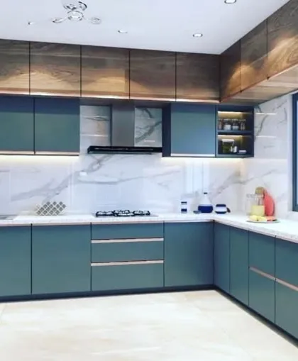 A contemporary kitchen featuring deep teal handleless cabinets paired with rich wood-grain overhead units. The white marble backsplash and countertop brighten the space, while under-cabinet lighting provides excellent task illumination.