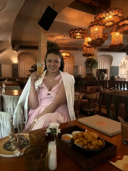 Enjoying a meal at Ophelia. For this outing, I paired a pink and white checked dress with a white blazer for a chic, layered look.