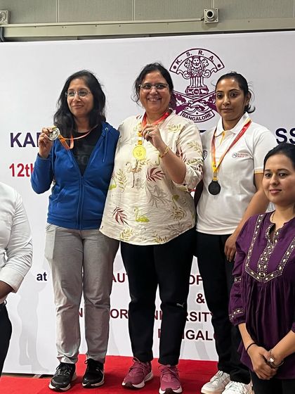 Rakhee on the podium after winning a silver medal in the Pistol Master women's category.