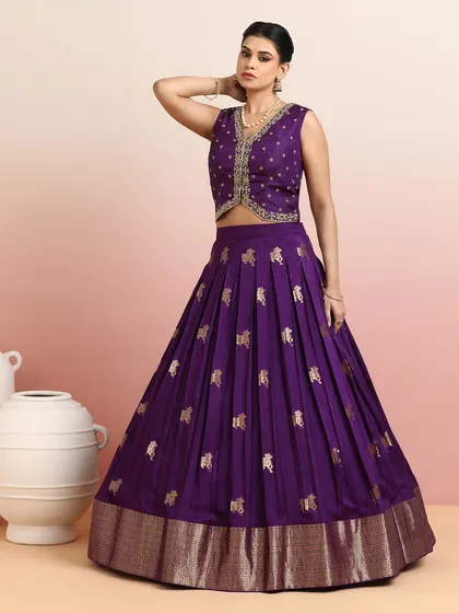 This royal purple lehenga is for the woman who is unafraid to make a statement. Adorned with golden motifs and a rich zari border, it is a regal creation designed for grand celebrations and unforgettable moments.