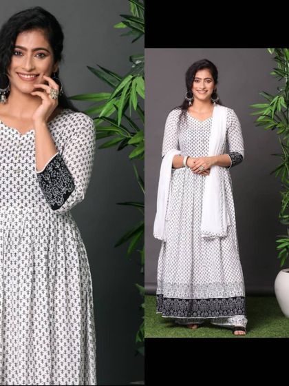 A similar shot to ID 38, showing the model in a white and black anarkali, offering a slightly different pose and smile.