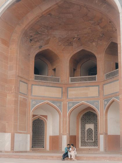 Capturing couples in large, historic spaces allows for a sense of scale and peace. Here, they are framed by the grand arches, making them the focal point in a vast, beautiful setting.