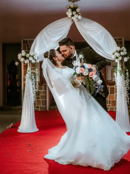 A classic, romantic dip and kiss under the wedding arch. This is a timeless wedding portrait that captures the romance and celebration of the moment you walk out of the church together.