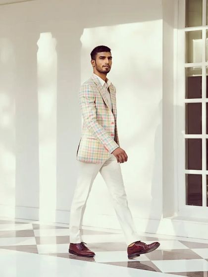 Elevate your style game with our impeccably tailored linen-silk-wool check jacket, where comfort meets sophistication.