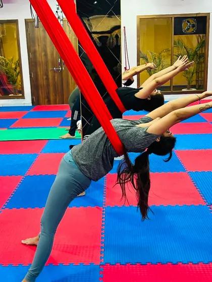 A supported bridge pose in the hammock helps to open the entire front of the body, from the chest to the hip flexors, creating a feeling of expansion.