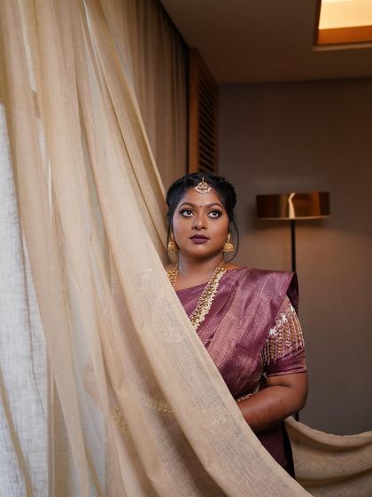 Dr. Preetha's engagement look in Pondicherry. We chose coppery gold eyes and deep wine lips, paired with a messy braid for a modern-traditional fusion.
