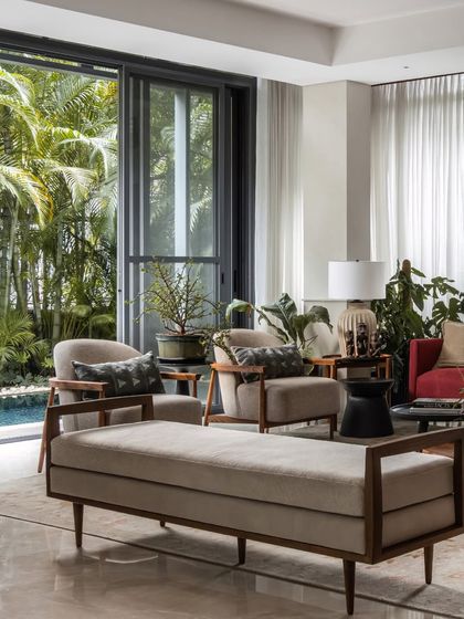 The open layout connects the living area directly to the poolside, making it perfect for entertaining. The furniture is arranged to encourage flow and conversation.
