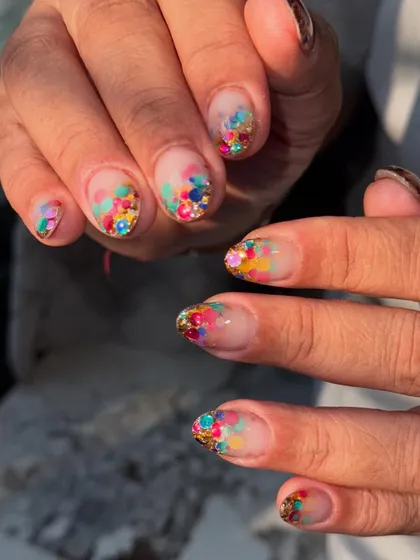 A full view of the playful and vibrant confetti glitter nails.