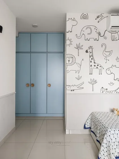 A wide view of a thoughtfully designed boy's room, featuring a playful black-and-white animal wallpaper. The space is kept open and clutter-free, allowing plenty of room for play.