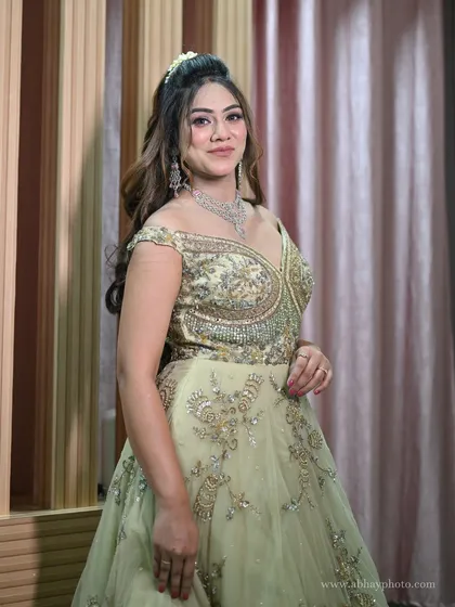 A three-quarter view of the elegant pastel green gown, perfect for showcasing its flattering silhouette and detailed embroidery.