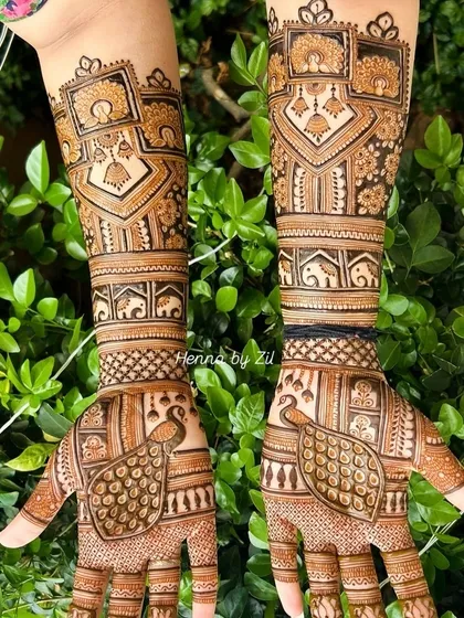 A close-up of the intricate patterns, showing the symmetrical design with peacocks on the palms and elephants on the arms.