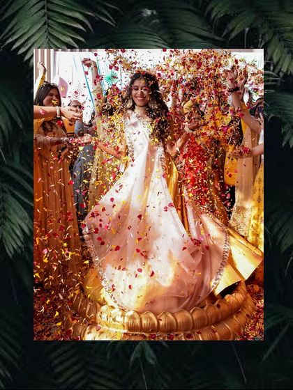 A vibrant photo of the bride's Haldi ceremony, framed with a tropical leaf border for an artistic touch.