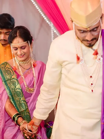 The couple holding hands as they walk together, symbolizing the start of their new journey.