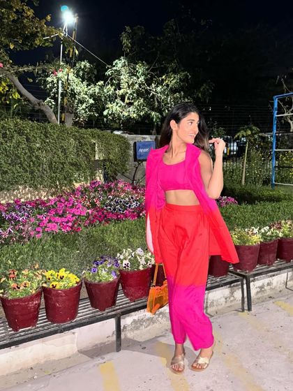 A bright and bold look for a Holi party. This color-blocked co-ord set in shades of pink and orange is fun, festive, and perfect for celebrating the festival of colors in style.