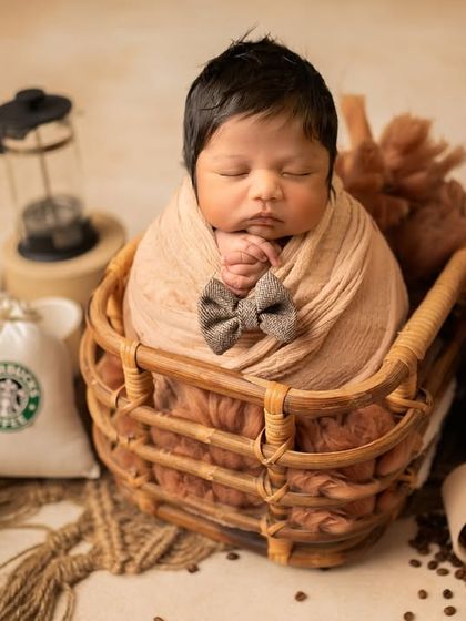 This little gentleman is perfectly posed with a tiny bow tie. The details in this coffee-themed newborn session make it a truly memorable one.