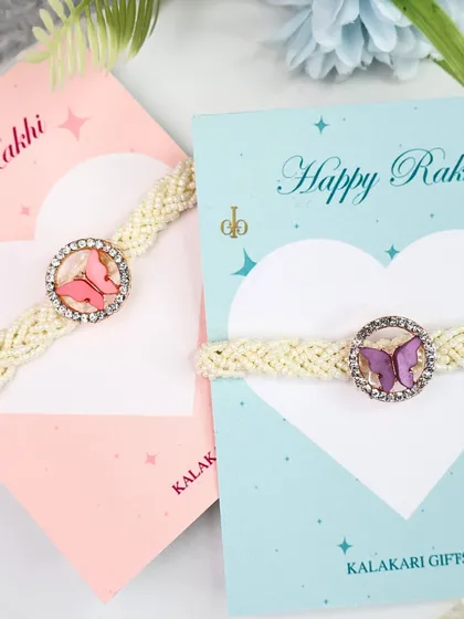 A beautiful pair of butterfly Lumba Rakhis for sisters, presented on "Happy Rakhi" cards. A perfect way to celebrate sisterhood.