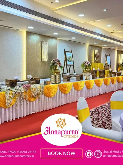 A well-decorated buffet line enhances the dining experience. Here, we used bright yellow drapes and floral arrangements to create a festive and inviting food station for a celebration.