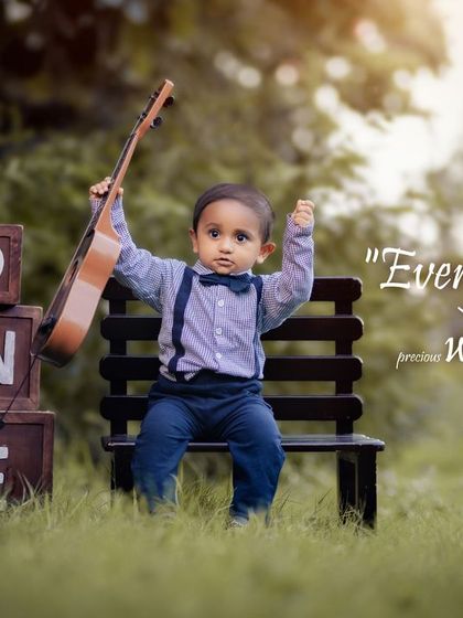 Every child is a gift. This little rockstar is ready to celebrate his first birthday with his guitar.
