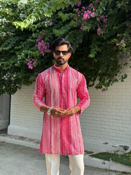 Add a splash of color to your wardrobe with this festive pink striped kurta. Paired with classic white trousers, it’s a stylish and comfortable option for celebrations like Raksha Bandhan or other family gatherings.